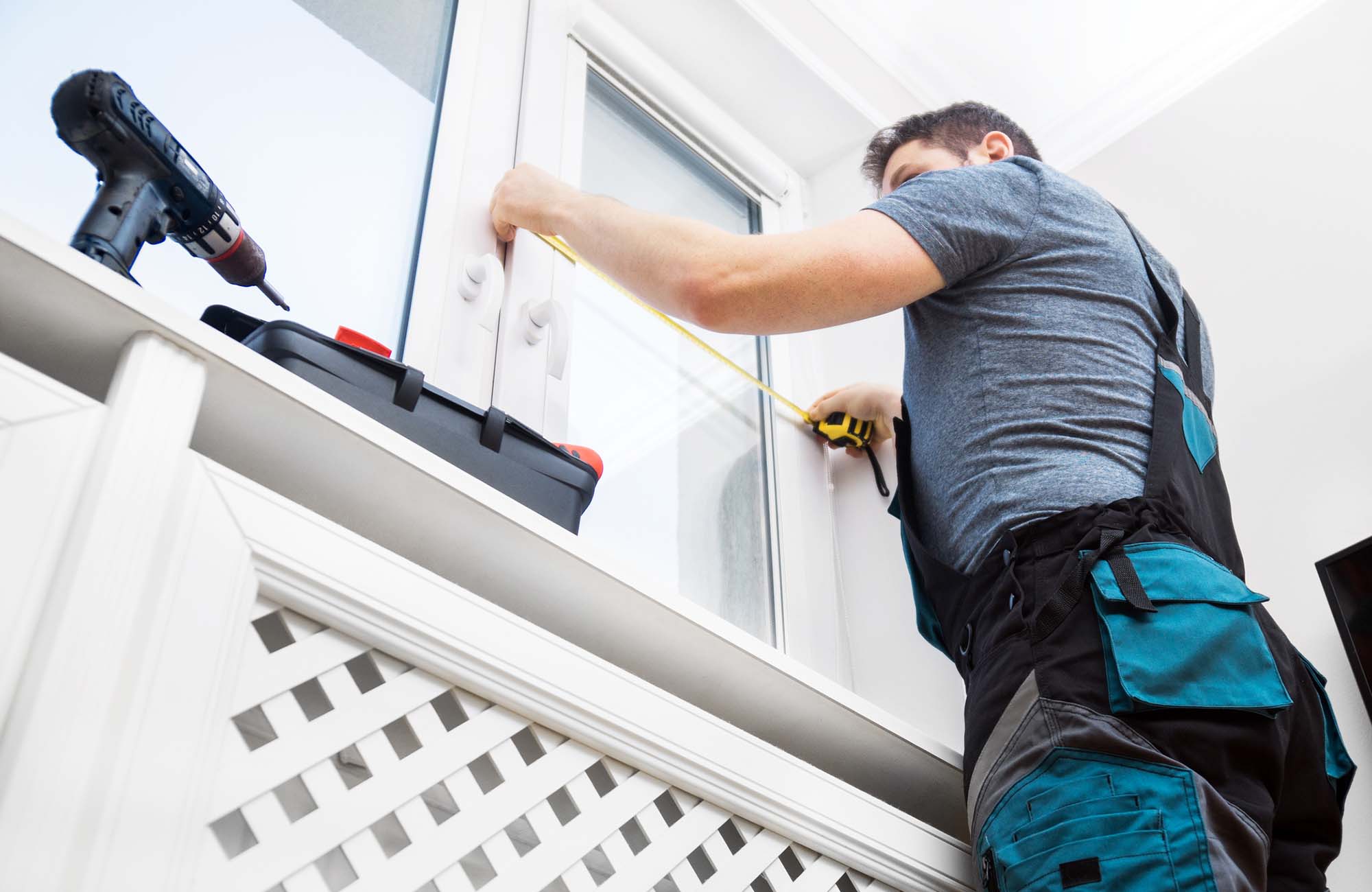 Man measuring upvc window frame